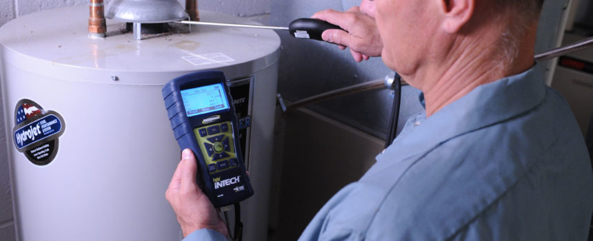 HVAC technician testing residential water heater with InTech Combustion Analyzer.