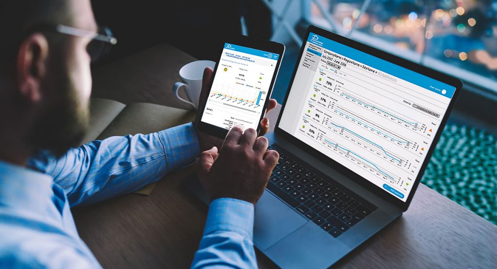 Manager reviewing Parasense Platform on tablet and laptop computer.